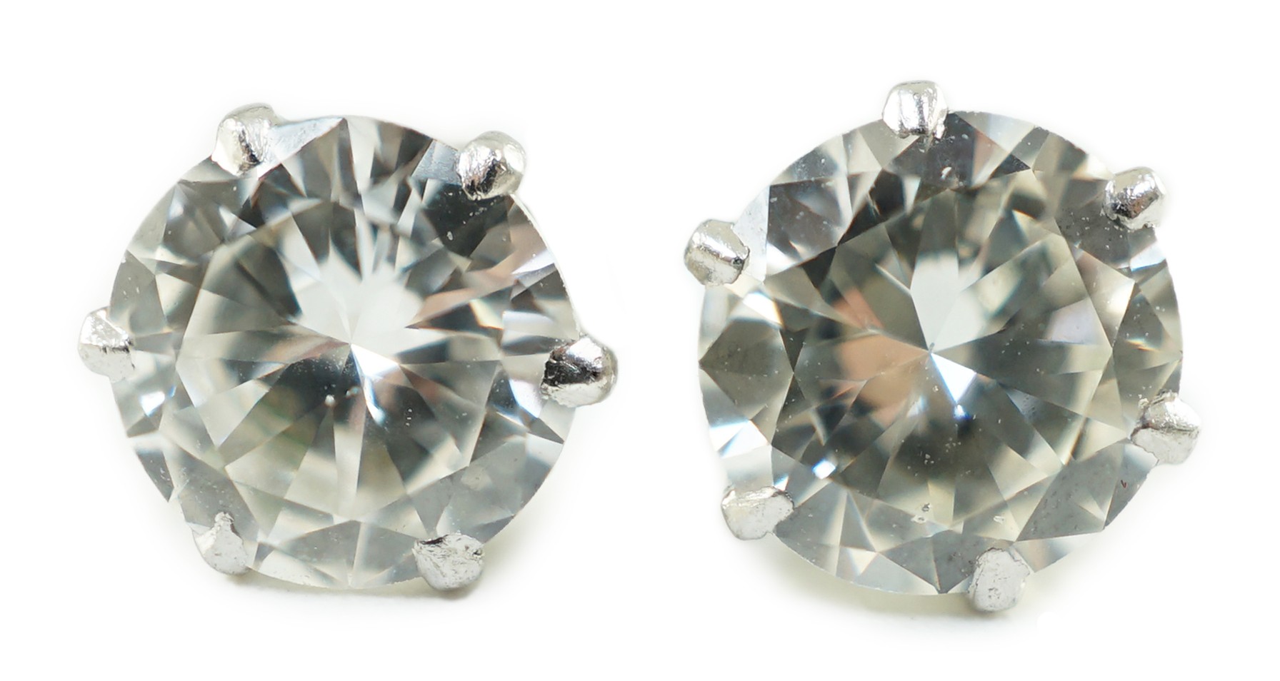 A pair of white gold and solitaire diamond set ear studs